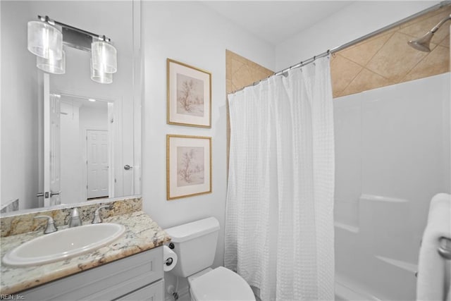 bathroom featuring vanity, curtained shower, and toilet