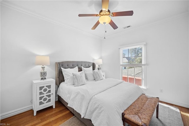 bedroom with crown molding, wood-type flooring, and ceiling fan