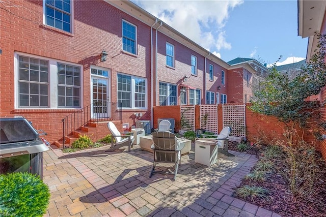 view of patio with area for grilling and a fire pit