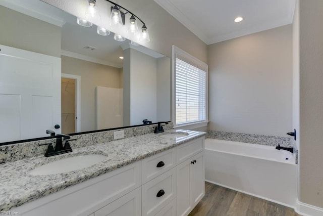 bathroom featuring crown molding, vanity, a bath, and hardwood / wood-style floors