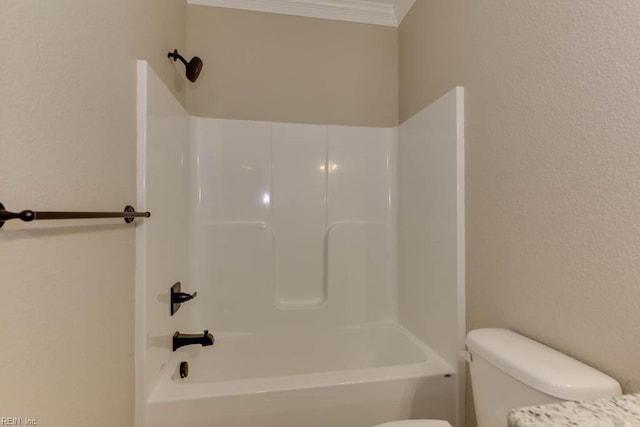 bathroom featuring shower / bathing tub combination, ornamental molding, and toilet