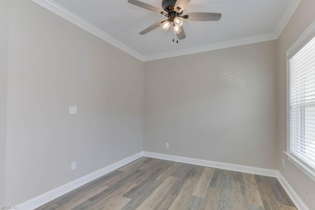 spare room with crown molding, hardwood / wood-style flooring, and a healthy amount of sunlight