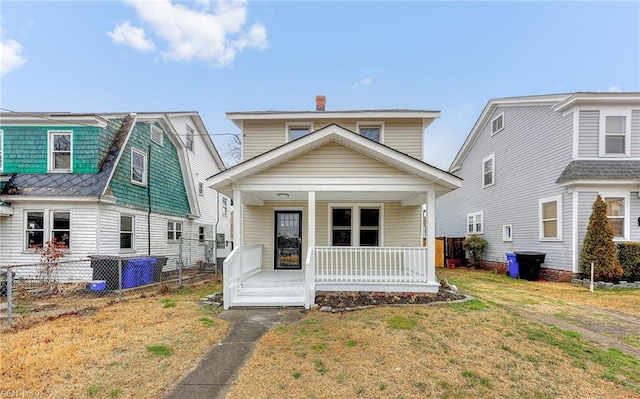 view of front of home featuring covered porch and a front yard