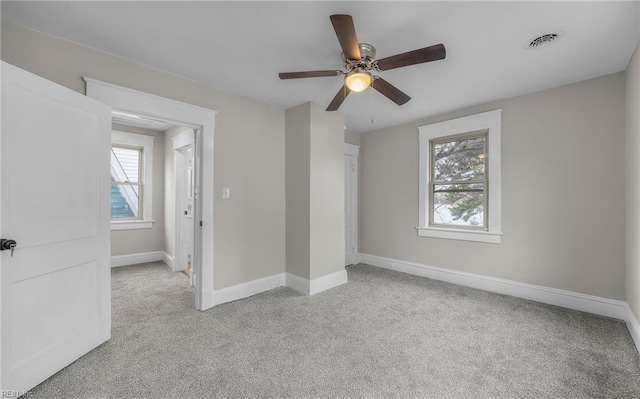 unfurnished bedroom featuring light carpet, visible vents, and baseboards