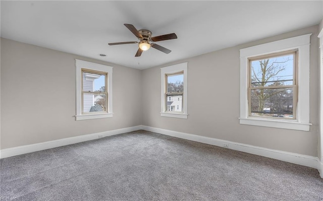 empty room featuring a ceiling fan, carpet flooring, and baseboards