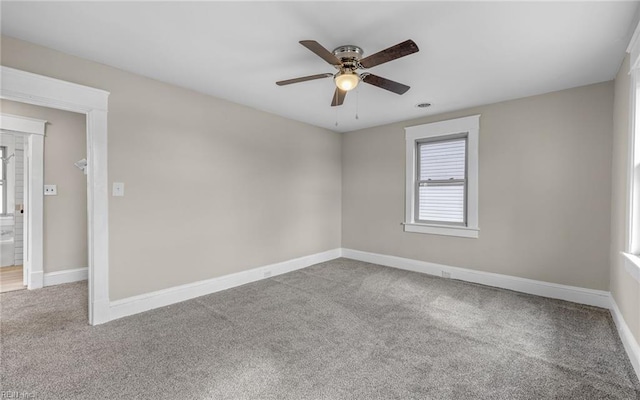 unfurnished room with ceiling fan, baseboards, and carpet flooring