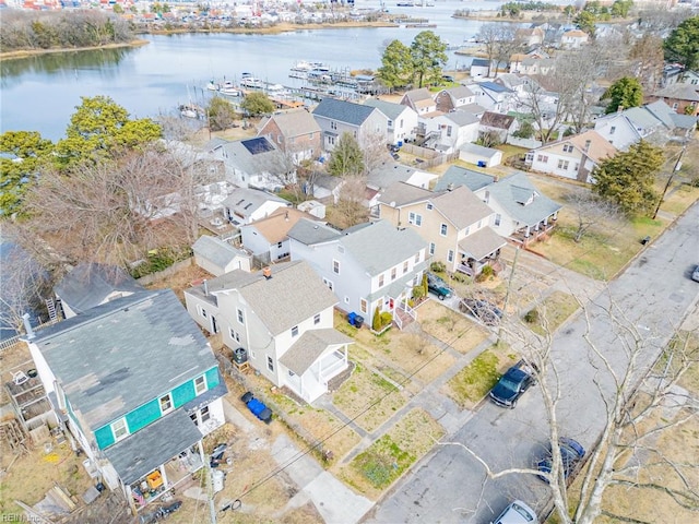 birds eye view of property with a water view and a residential view