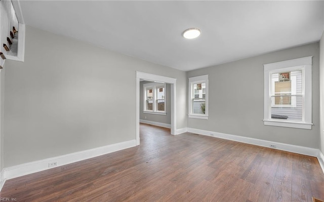 spare room featuring dark wood-type flooring