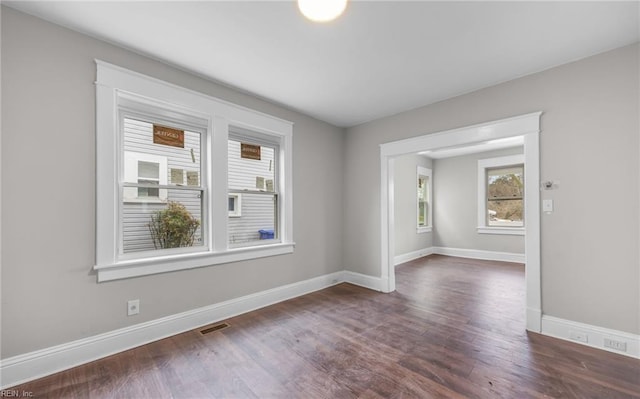 spare room featuring dark hardwood / wood-style floors