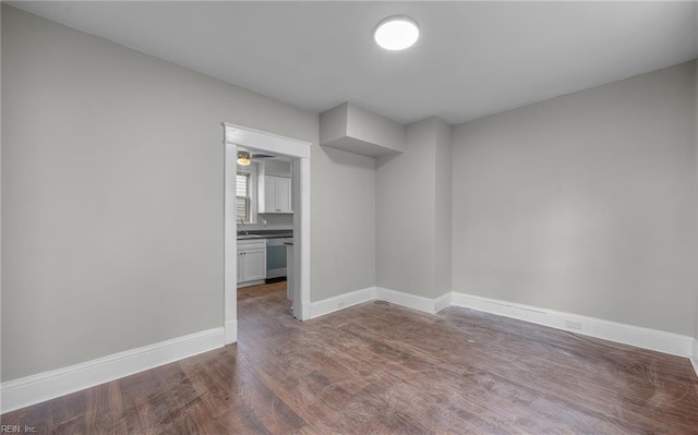 empty room with hardwood / wood-style flooring and sink