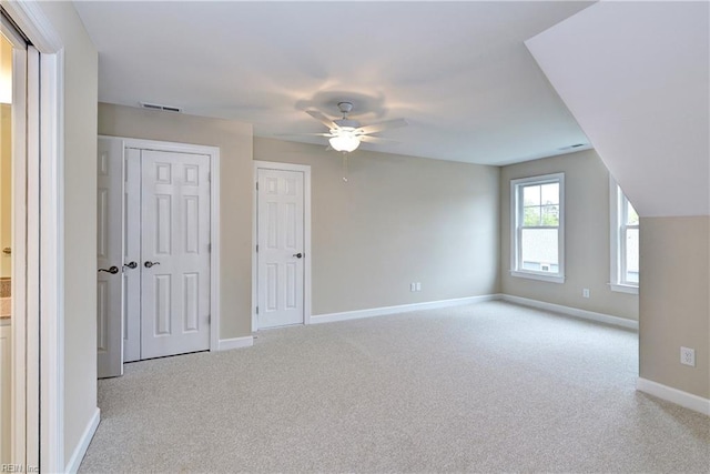 unfurnished bedroom featuring baseboards, visible vents, and carpet floors