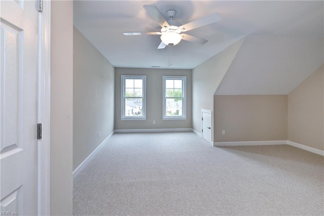 additional living space featuring carpet flooring, ceiling fan, and baseboards