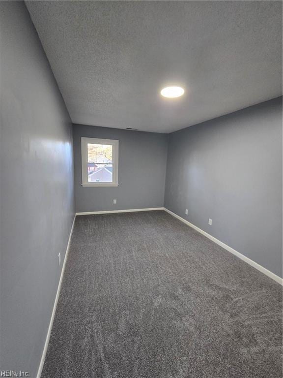 spare room with carpet floors and a textured ceiling