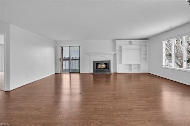 unfurnished living room featuring dark wood-type flooring