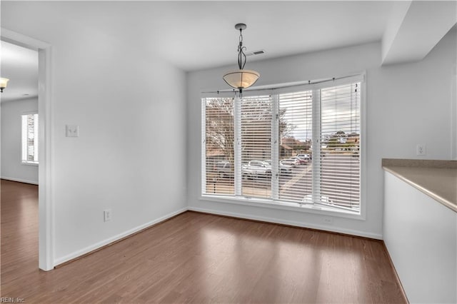 unfurnished dining area with hardwood / wood-style flooring