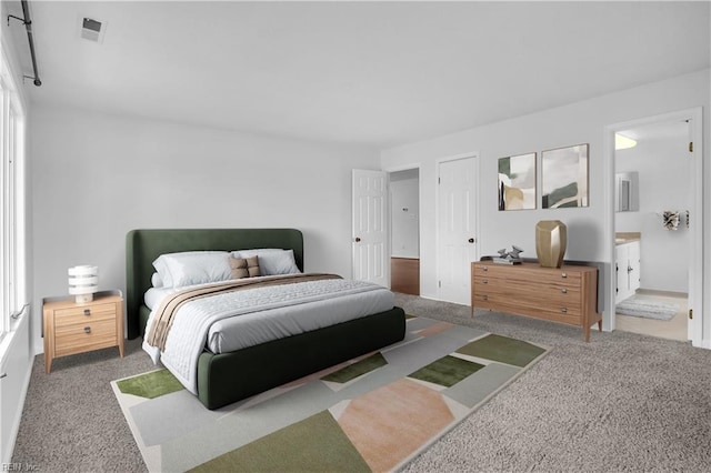 carpeted bedroom featuring ensuite bathroom