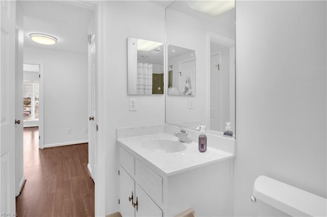 bathroom featuring vanity, toilet, and wood-type flooring