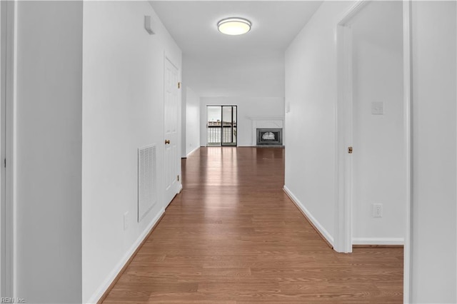 hallway with hardwood / wood-style floors