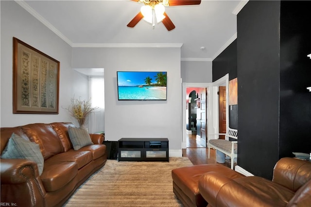 living room featuring ceiling fan and crown molding