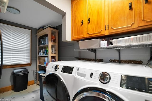 laundry room with cabinets and washing machine and clothes dryer