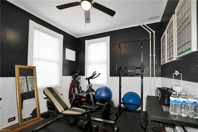 workout area featuring crown molding and ceiling fan