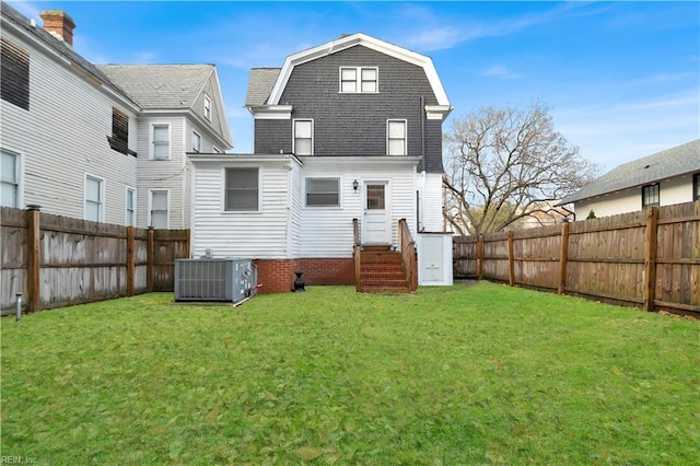 back of property featuring central AC unit and a lawn