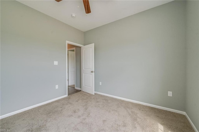 unfurnished room with light colored carpet and ceiling fan