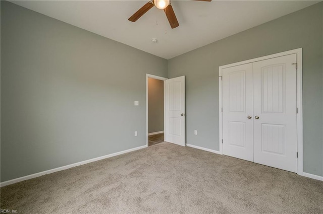 unfurnished bedroom featuring light colored carpet, a closet, and ceiling fan