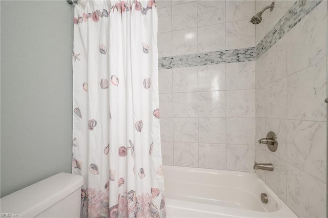 bathroom with toilet and shower / bath combo with shower curtain