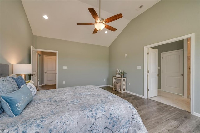 bedroom featuring hardwood / wood-style floors, high vaulted ceiling, and ceiling fan