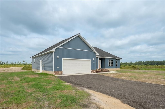 view of front of home with a garage and a front yard