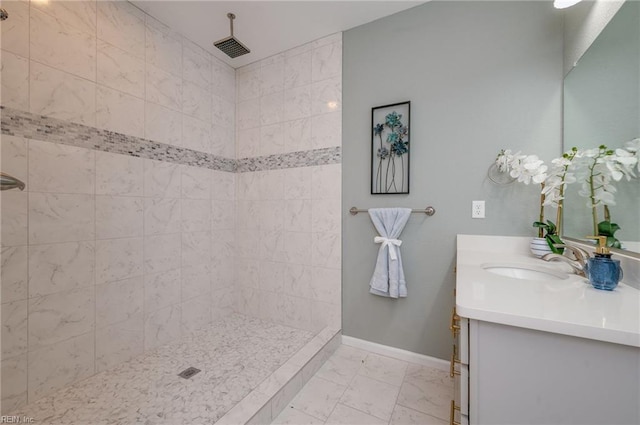 bathroom featuring vanity and tiled shower