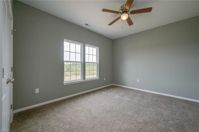 unfurnished room with ceiling fan and carpet flooring