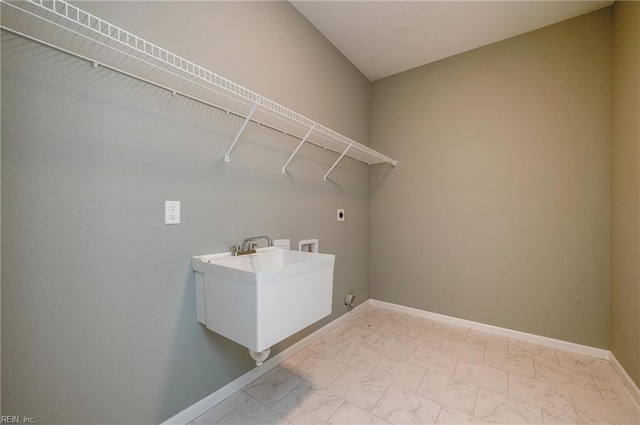 clothes washing area with washer hookup, sink, and hookup for an electric dryer