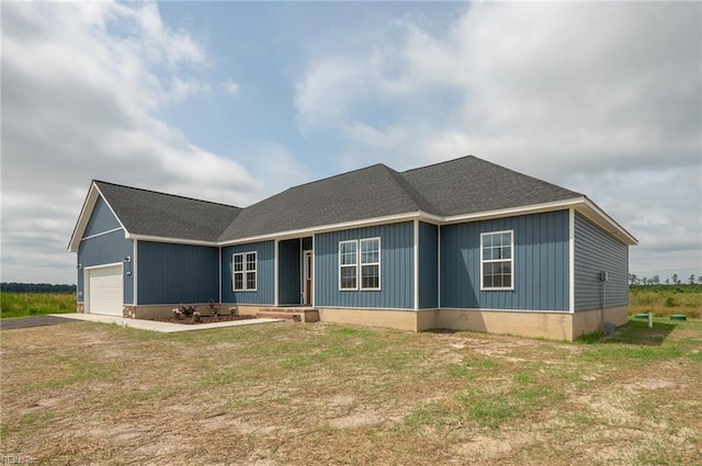 view of front of property with a garage and a front yard