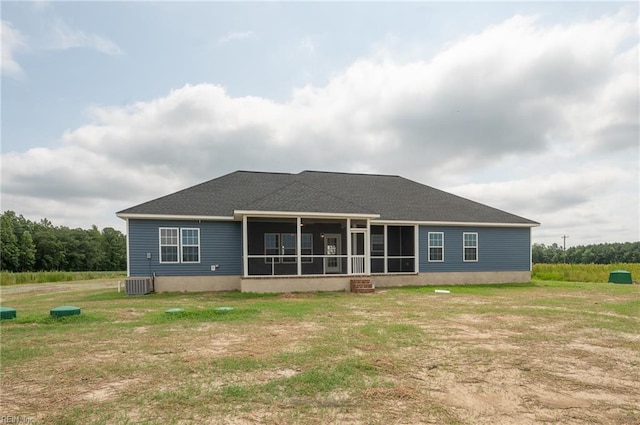 rear view of property with a lawn and a sunroom