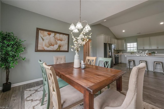 dining space with dark wood-type flooring and vaulted ceiling