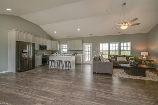 living room with dark wood-type flooring, high vaulted ceiling, and ceiling fan