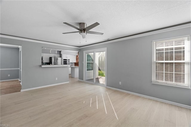 unfurnished living room featuring ornamental molding, a textured ceiling, ceiling fan, and light hardwood / wood-style flooring