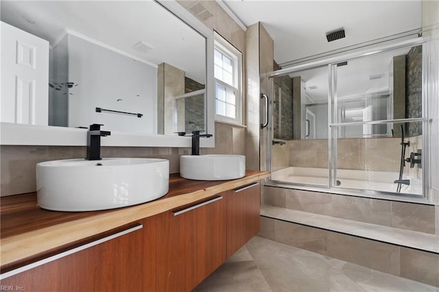 bathroom with vanity and combined bath / shower with glass door