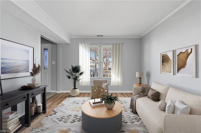 living room with ornamental molding and hardwood / wood-style floors