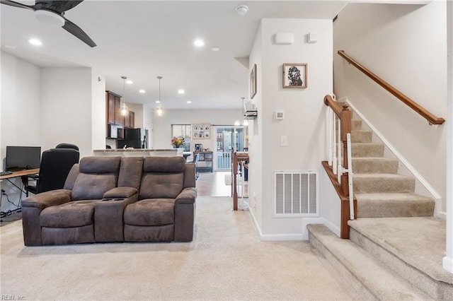 living room with ceiling fan and light carpet