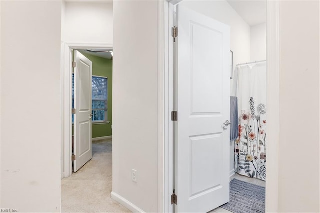 hallway with light colored carpet