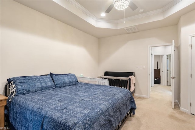 carpeted bedroom featuring crown molding, ceiling fan, and a tray ceiling