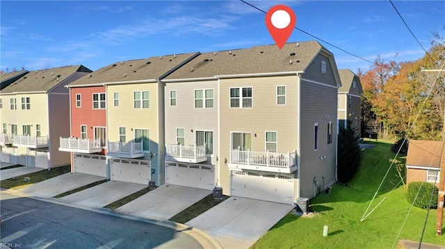 rear view of house with central AC, a balcony, a garage, and a yard