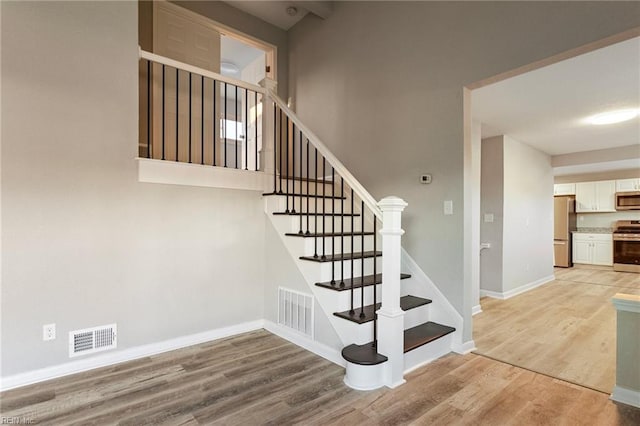 staircase featuring hardwood / wood-style flooring