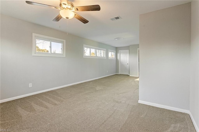 carpeted spare room with ceiling fan