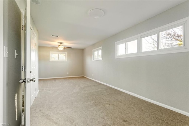 spare room with light colored carpet and ceiling fan