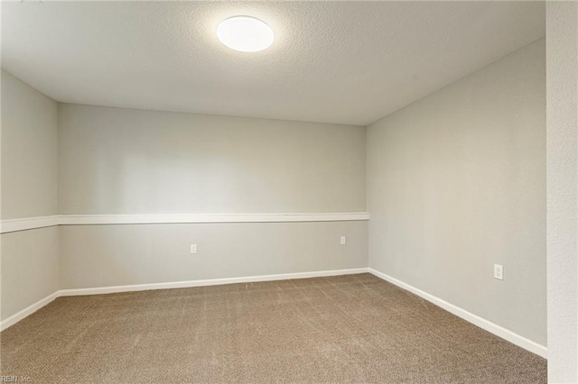 empty room with carpet flooring and a textured ceiling