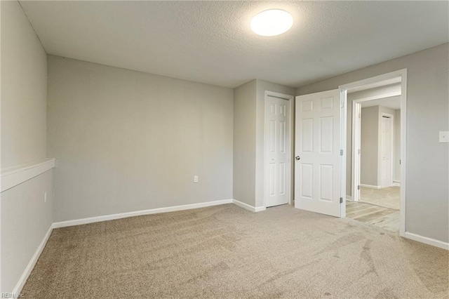 unfurnished bedroom featuring a closet, carpet floors, and a textured ceiling